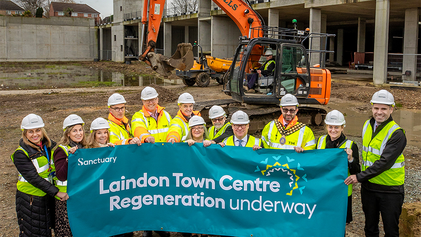 Sanctuary staff members and Councillors pose at the Laindon site with a banner that reads 'Laindon Town Centre Regeneration underway'