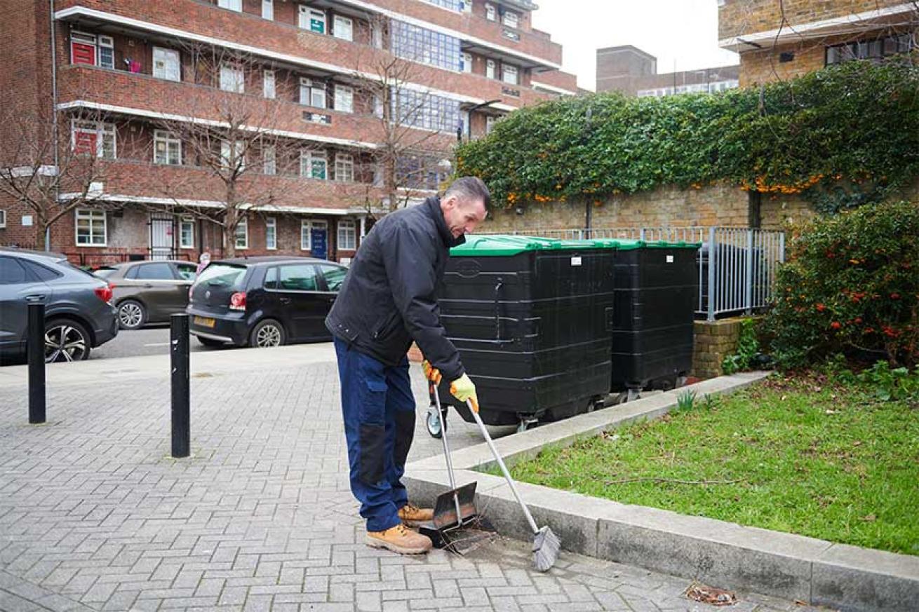 Sanctuary staff member sweeping up debris