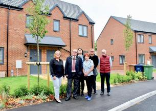 Sanctuary staff members and local councillors stood outside of affordable homes in March